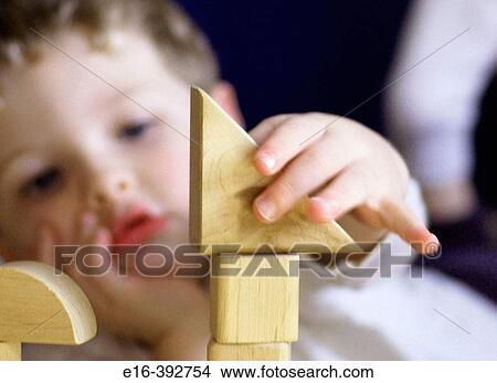 Boy concentrating on building blocks View Large Photo Image Picture - Boy concentrating on building blocks. Fotosearch