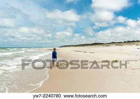 Boy digging canal on beach near Bialog? ra, Poland. View Large Photo Image Stock Image - Boy digging canal on beach near Bialog? ra, Poland.. Fotosearch