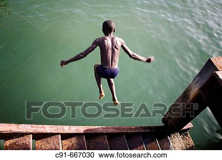 Boy diving. Gambia View Large Photo Image Stock Image - Boy diving. Gambia. Fotosearch