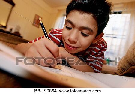 Picture - Boy doing homework. Fotosearch