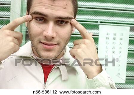 Boy doing Oriental eyes. View Large Photo Image Stock Image - Boy doing Oriental eyes.. Fotosearch