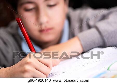 Stock Image - Boy doing the homeworks. Fotosearch