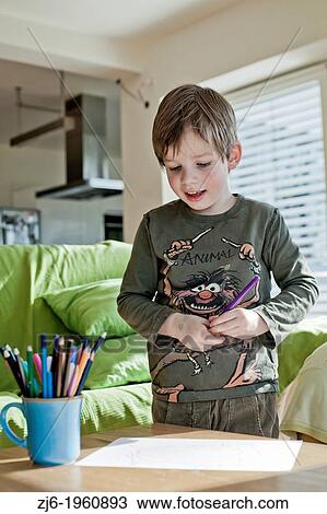 Boy draws with crayons indoor. View Large Photo Image Stock Image - Boy draws with crayons indoor.. Fotosearch