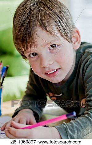 Boy draws with crayons indoor. View Large Photo Image Stock Photo - Boy draws with crayons indoor.. Fotosearch
