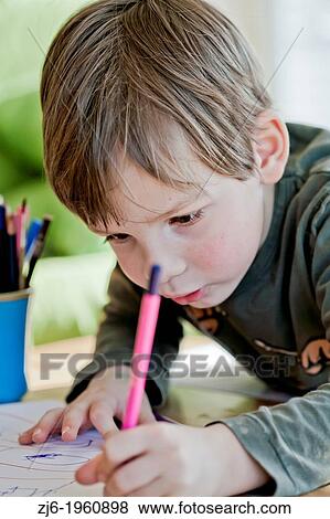 Boy draws with crayons indoor. View Large Photo Image Stock Photo - Boy draws with crayons indoor.. Fotosearch