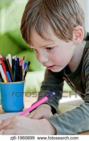 Boy draws with crayons indoor. View Large Photo Image Stock Photo - Boy draws with crayons indoor.. Fotosearch