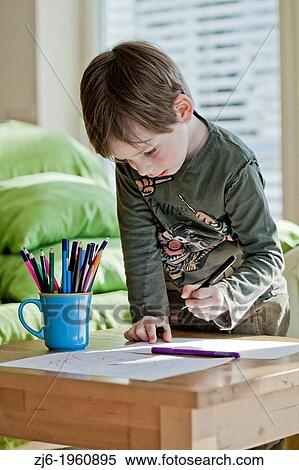 Boy draws with crayons indoor. View Large Photo Image Stock Photography - Boy draws with crayons indoor.. Fotosearch