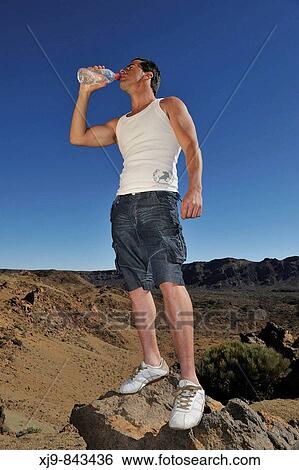 Boy drinking on the summit of the volcano Teide. View Large Photo Image Stock Photograph - Boy drinking on the summit of the volcano Teide.. Fotosearch