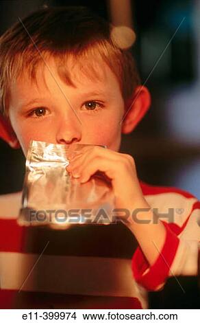 Boy drinks from juice pouch, lifestyle View Large Photo Image Picture - Boy drinks from juice pouch, lifestyle. Fotosearch