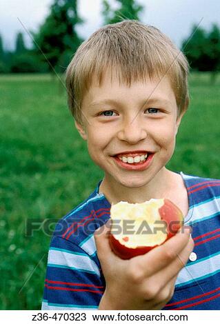Boy eating apple View Large Photo Image Stock Image - Boy eating apple. Fotosearch