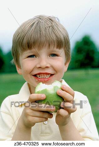 Boy eating apple View Large Photo Image Stock Photography - Boy eating apple. Fotosearch