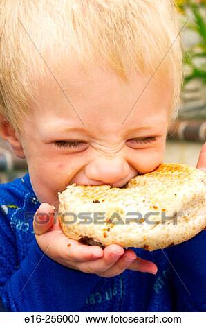 boy eating bagel View Large Photo Image Stock Image - boy eating bagel. Fotosearch