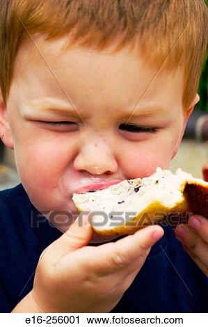 Boy eating bagel View Large Photo Image Stock Image - Boy eating bagel. Fotosearch