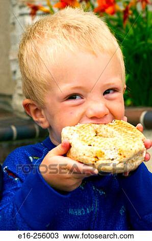 boy eating bagel View Large Photo Image Stock Image - boy eating bagel. Fotosearch