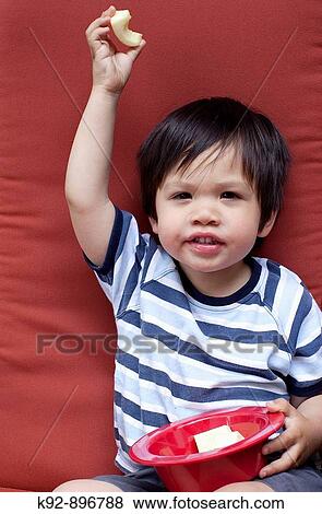 Stock Photo - Boy eating healthy food. Fotosearch