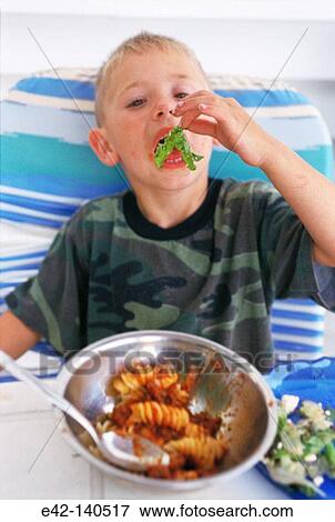 Boy eating italian food View Large Photo Image Stock Photo - Boy eating italian food. Fotosearch