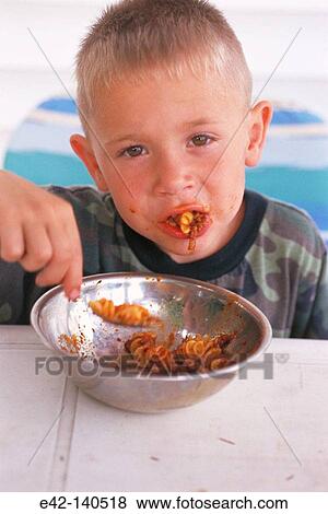 Stock Photo - Boy eating italian food. Fotosearch