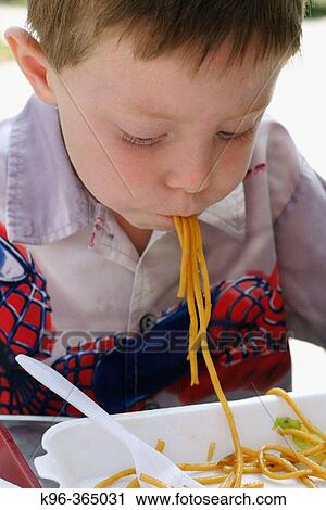 Boy eating pasta View Large Photo Image Stock Image - Boy eating pasta. Fotosearch