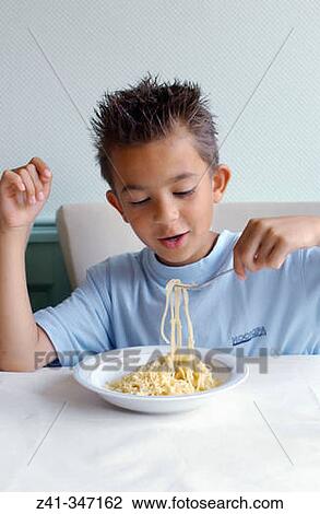Boy eating pasta View Large Photo Image Stock Image - Boy eating pasta. Fotosearch