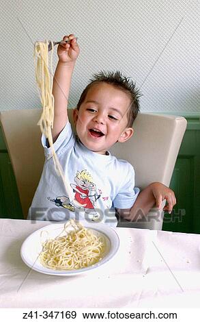 Boy eating pasta View Large Photo Image Stock Photo - Boy eating pasta. Fotosearch