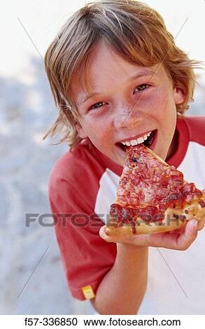 Boy eating pizza View Large Photo Image Stock Image - Boy eating pizza. Fotosearch