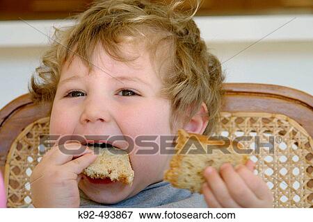 Boy eating sandwich. View Large Photo Image Stock Photo - Boy eating sandwich.. Fotosearch