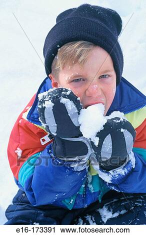Boy eating snow View Large Photo Image Stock Image - Boy eating snow. Fotosearch