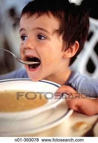 Boy eating soup View Large Photo Image Stock Photo - Boy eating soup. Fotosearch