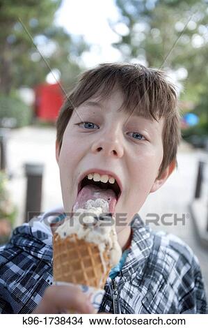 Picture - boy enjoying an ice cream cone. Fotosearch
