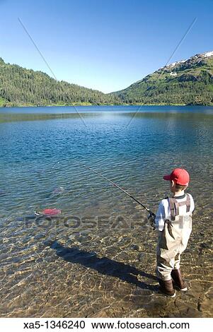 Boy fishing for salmon, Shrode Lake, Prince William Sound, Alaska, USA View Large Photo Image Stock Image - Boy fishing for salmon, Shrode Lake, Prince William Sound, Alaska, USA. Fotosearch