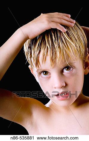 Boy fixing hair in mirror View Large Photo Image Stock Image - Boy fixing hair in mirror. Fotosearch