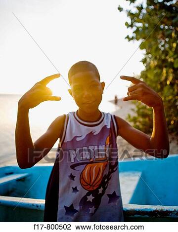 boy flexing in sunset light, dominican republic. View Large Photo Image Stock Image - boy flexing in sunset light, dominican republic.. Fotosearch