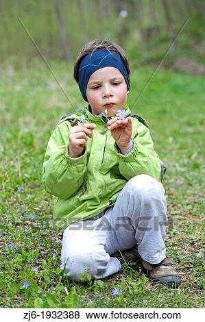 Boy gathering flowers early in the spring. View Large Photo Image Stock Photo - Boy gathering flowers early in the spring.. Fotosearch