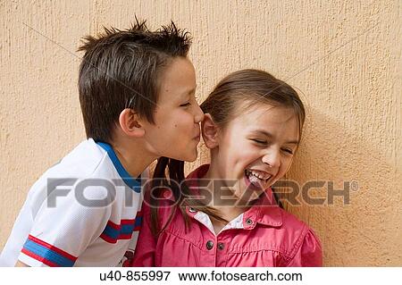 Stock Photo - Boy giving girl first kiss. Fotosearch