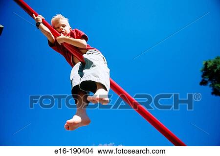 Boy hanging on to playground bar View Large Photo Image Picture - Boy hanging on to playground bar. Fotosearch