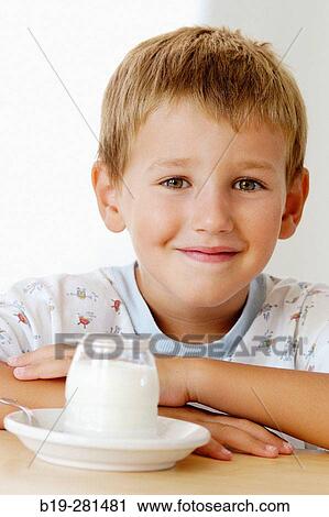 Boy having a white yoghurt View Large Photo Image Stock Image - Boy having a white yoghurt. Fotosearch