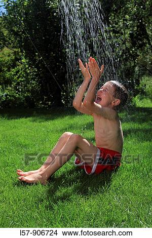 boy having shower outdoors, Switzerland View Large Photo Image Picture - boy having shower outdoors, Switzerland. Fotosearch
