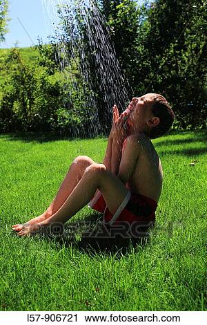 boy having shower outdoors, Switzerland View Large Photo Image Stock Image - boy having shower outdoors, Switzerland. Fotosearch