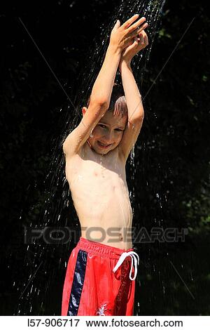 boy having shower outdoors, Switzerland View Large Photo Image Stock Photo - boy having shower outdoors, Switzerland. Fotosearch