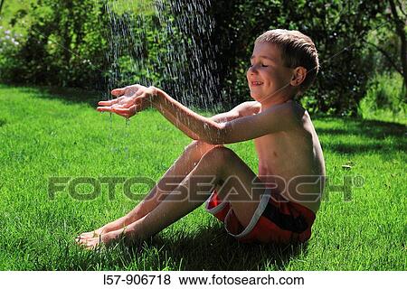 boy having shower outdoors, Switzerland View Large Photo Image Stock Photo - boy having shower outdoors, Switzerland. Fotosearch