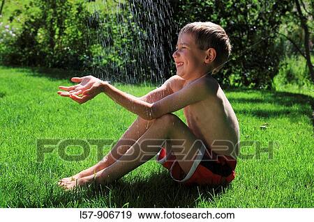 boy having shower outdoors, Switzerland View Large Photo Image Stock Photo - boy having shower outdoors, Switzerland. Fotosearch