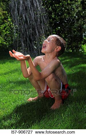 boy having shower outdoors, Switzerland View Large Photo Image Stock Photo - boy having shower outdoors, Switzerland. Fotosearch