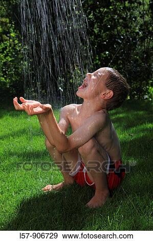 boy having shower outdoors, Switzerland View Large Photo Image Stock Photo - boy having shower outdoors, Switzerland. Fotosearch