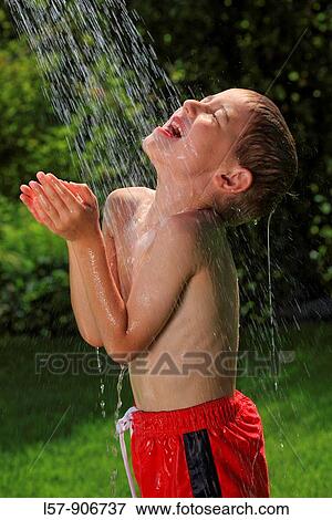 boy having shower outdoors, Switzerland View Large Photo Image Stock Photo - boy having shower outdoors, Switzerland. Fotosearch
