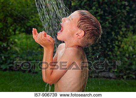 boy having shower outdoors, Switzerland View Large Photo Image Stock Photo - boy having shower outdoors, Switzerland. Fotosearch