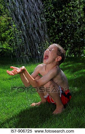 boy having shower outdoors, Switzerland View Large Photo Image Stock Photography - boy having shower outdoors, Switzerland. Fotosearch