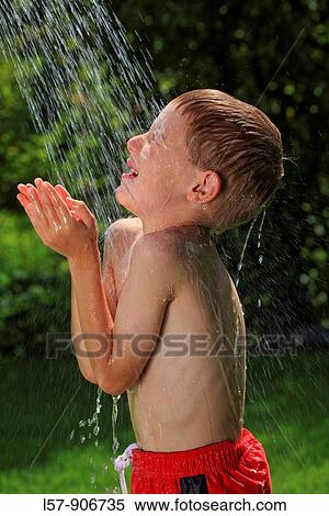 boy having shower outdoors, Switzerland View Large Photo Image Stock Photography - boy having shower outdoors, Switzerland. Fotosearch