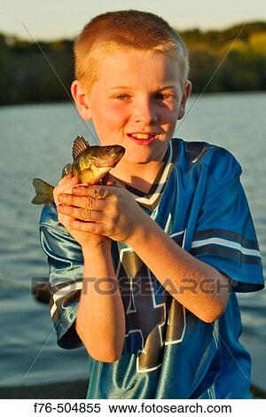Stock Photography - Boy holding fish. Fotosearch