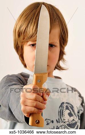 Boy holding knife View Large Photo Image Stock Photograph - Boy holding knife. Fotosearch