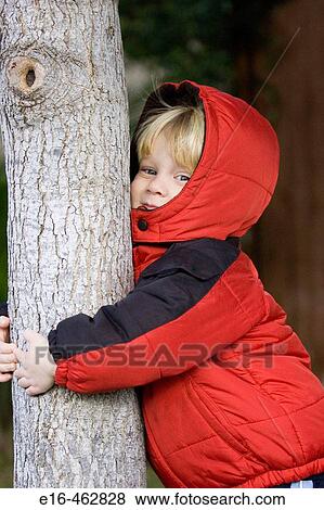 Stock Photo - Boy hugging tree. Fotosearch